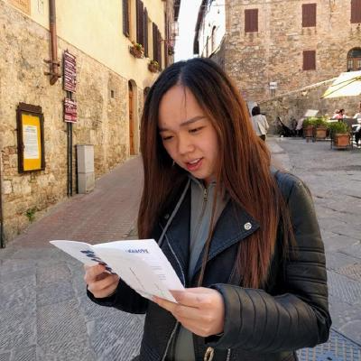 picture of me looking at a map in a cobbled street in italy